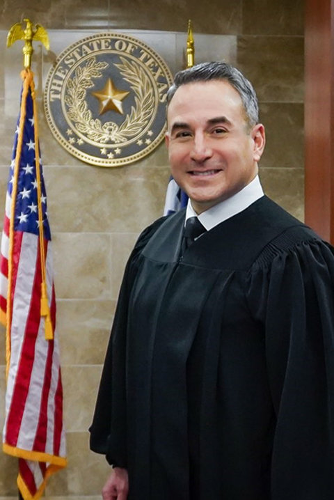 An Aug. 19 injunction against Texas Governor Greg Abbott's executive order against mask mandates has been issued by 434th District Judge Christian Becerra, pictured above. The injunction allows school districts and other governments in Fort Bend County to require masks to fight the spread of COVID-19.